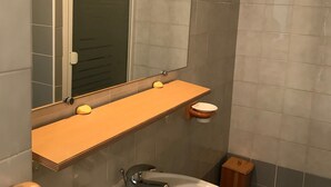 A bathroom with a wooden vanity, a mirror, and a toilet. - Cozy apartment with balcony and park view in Villard-de-Lans (Villard-de-Lans)