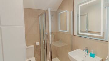 Shower, hair dryer, slippers, towels