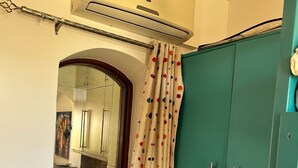 A bathroom with a shower curtain, a towel rack, and a green cabinet.