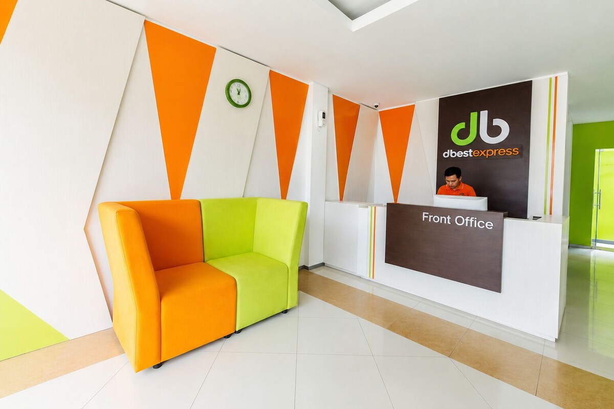 A reception area with a modern design, including a reception desk labeled 'Front Office' and a seating area with a sofa.