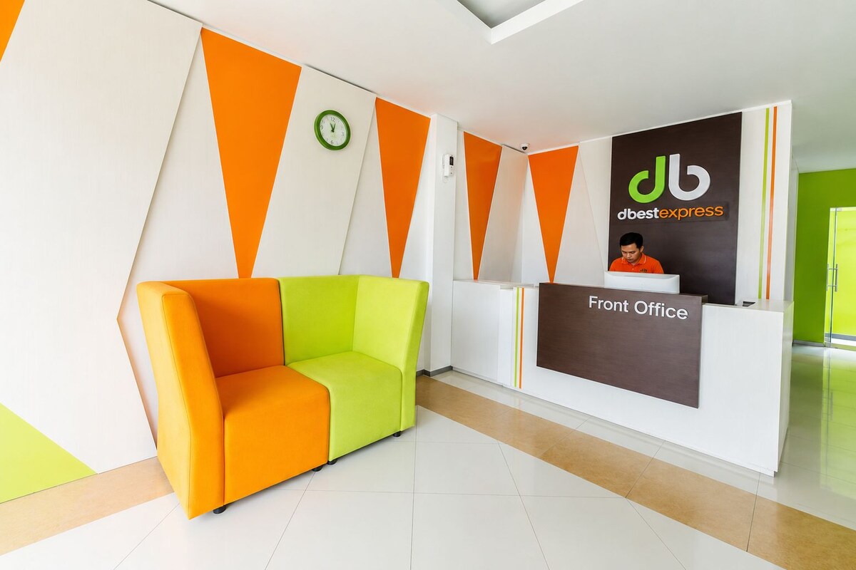 A reception area with a modern design, including a reception desk labeled 'Front Office' and a seating area with a sofa.