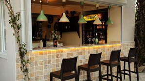 A bar area with a tiled backsplash, three wicker chairs, and hanging pendant lights. - SO DALYAN (Dalyan)