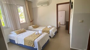 A hotel room with two beds, a bathroom, and a hallway. - SO DALYAN (Dalyan)