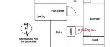 A floor plan of a house with a living room, kitchen, dining area, guest bedroom, master bedroom, and a landing area.