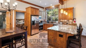 A spacious kitchen with wooden cabinets, a granite countertop, and a built-in island. - 4 Bedroom w Swimming Pool Close to Hyatt (FP1-24) (Incline Village)