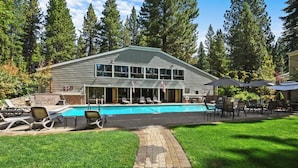 A two-story building with a swimming pool, outdoor seating, and a well-maintained lawn. - 4 Bedroom w Swimming Pool Close to Hyatt (FP1-24) (Incline Village)