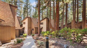 A row of cabins with a paved walkway and surrounding trees. - Cozy 2BR Condo Near Diamond Peak (AT5) (Incline Village)