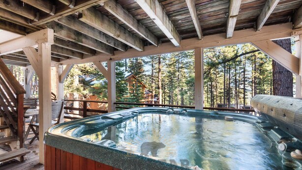 A hot tub in a wooden cabin with a view of a forest. - 3 Bedroom w Hot Tub and Forest Views (829EL) (Incline Village)