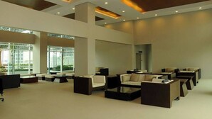 A spacious lobby with modern seating arrangements, large windows, and a high ceiling with recessed lighting. - The Beacon 1Br for 4, Tower 2, WiFi 300Mbps (Makati City)