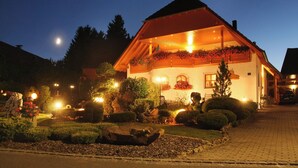A traditional chalet-style building with a sloped roof, surrounded by well-maintained gardens and a paved driveway. - Kleingesee approx. 5 km from Gössweinstein Holiday apartment Haus Sonnenscheim (Gößweinstein)