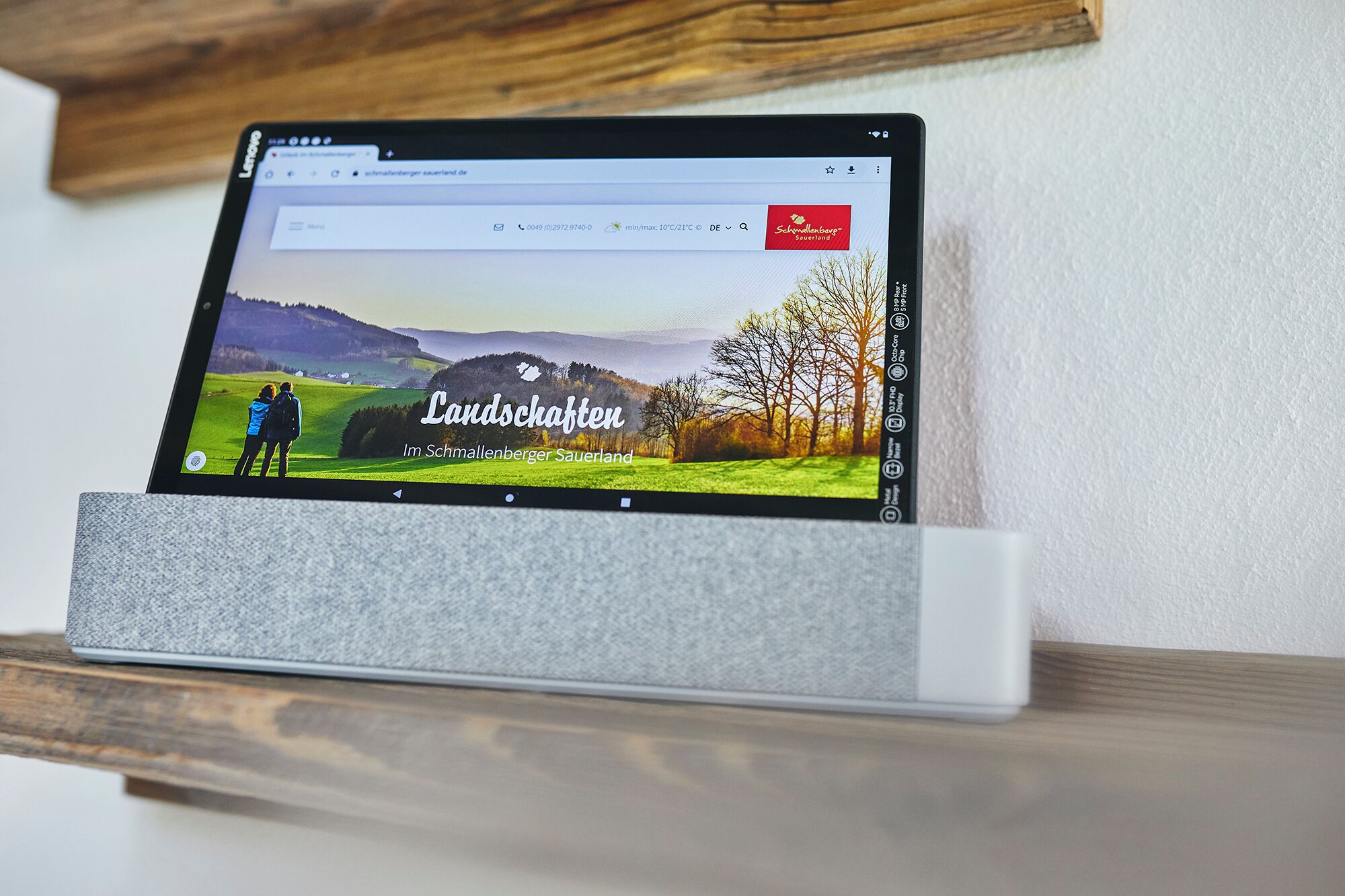 A tablet displaying a webpage with a scenic landscape and text 'Landschaften Im Schmalenberger Sauerland'.