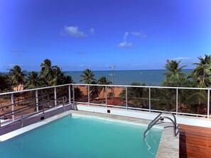 Une piscine avec vue sur la plage et l’océan.