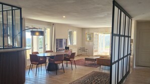 A spacious living area with a dining table, chairs, and a large window. - EXCEPTIONAL VIEW of Mt. Ventoux, between the Ardèche Gorges and the Cèze Valley (Salazac)