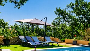 A swimming pool with lounge chairs and a pergola. - EXCEPTIONAL VIEW of Mt. Ventoux, between the Ardèche Gorges and the Cèze Valley (Salazac)