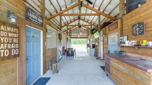 A spacious indoor area with a wooden ceiling and a sign reading "The Smith & Co. Laundry Room". - Farmhouse Hideaway w/ Covered Patio in Kissimmee (Kissimmee)