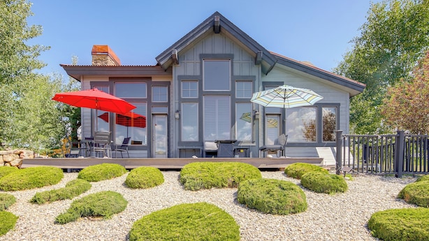 A modern house with a covered patio, a stone pathway, and neatly trimmed bushes. - Grand Elk Golf Club On-site: Mtn-view Home w/ Deck (Granby)