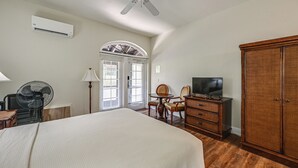 A bedroom with a bed, a ceiling fan, a TV, a wardrobe, and a desk with a chair. - Everglades Escape w/ Heated Pool & Marina Access! (Naples)