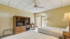 A hotel room with two beds, a television, a microwave, and a dining area with chairs and a table. - Marina, Heated Pool & Game Room: Naples Condo! (Naples)