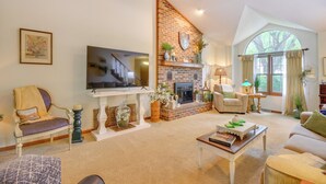 A cozy living room with a fireplace, comfortable seating, and a television. - 3 Mi to Dtwn Jefferson City: Family Home w/ Deck (Jefferson City)