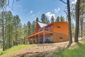 A wooden cabin with a balcony, surrounded by trees. - 3 Mi to Resort: Year-round Angel Fire Getaway! (Angel Fire)