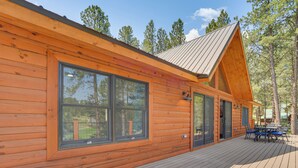 A log cabin with large windows, a deck, and a metal roof. - 3 Mi to Resort: Year-round Angel Fire Getaway! (Angel Fire)