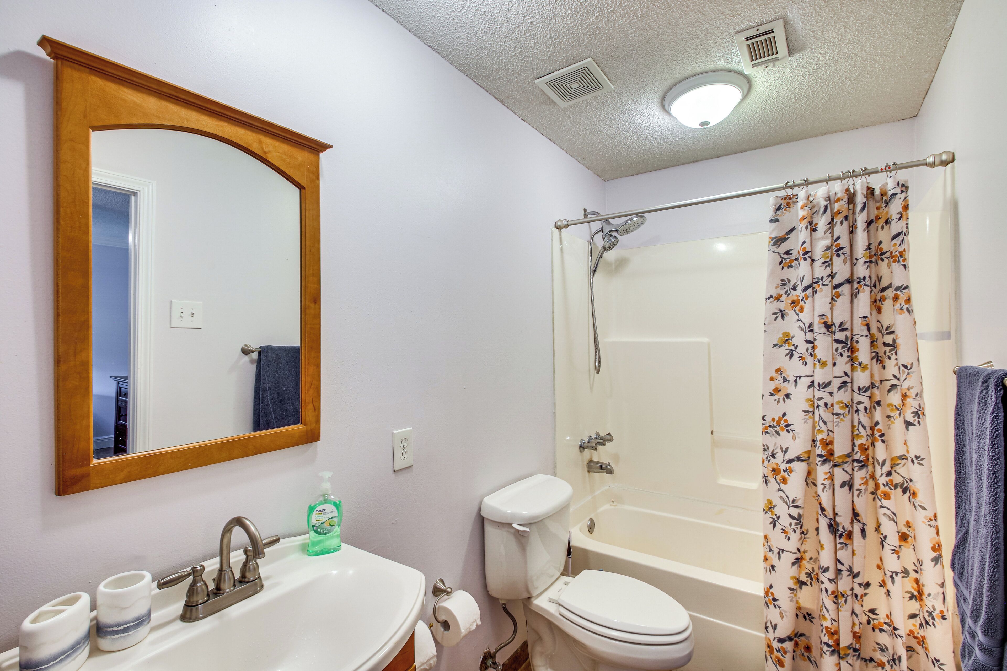 A bathroom with a sink, toilet, and bathtub.