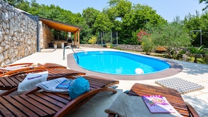 A pool with wooden loungers and a stone wall. - Villa Risika 1 with pool island Krk by Villas Guid (Risika)