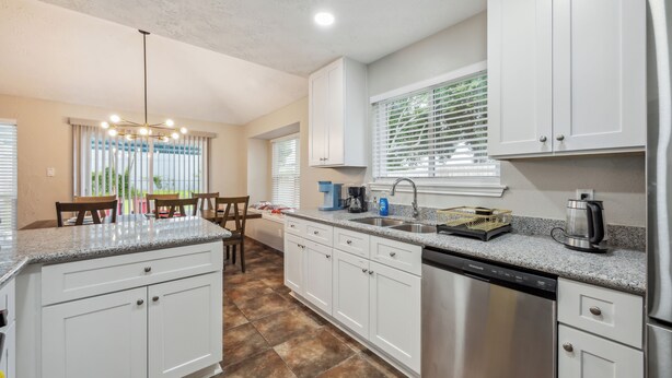 A modern kitchen with white cabinets, granite countertops, and stainless steel appliances. - Space & Sunshine Retreat/3BR Near NASA & NRG (Houston)