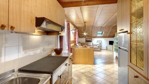A modern kitchen with wooden cabinets, a stainless steel sink, and a built-in stove.
