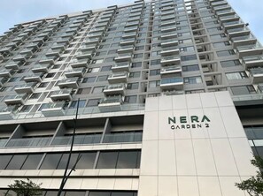 A high-rise building with multiple balconies and a sign that reads "NERA GARDEN 2". - Yugen Hue Homestay, Apartment with 2 bedrooms, free swimming pool and gym (Thành phố Huế)