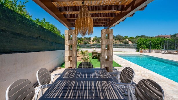 An outdoor pool area with a pergola, seating, and a view of the landscape. - Villa Rita Ostuni with pool by Rentbeat  (Ostuni)