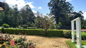 A paved courtyard with a pathway, surrounded by well-maintained hedges and various plants. - The Hill Cliff Nuwara Eliya (Nuwara eliya)