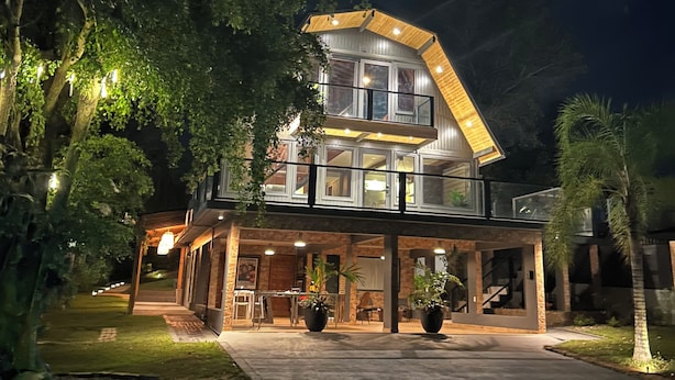 A modern two-story house with a covered patio and a large driveway. - VILLA PR, Pool, Basketball Court, Private (Vega Baja)