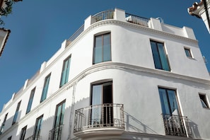 A white building with multiple windows and balconies.