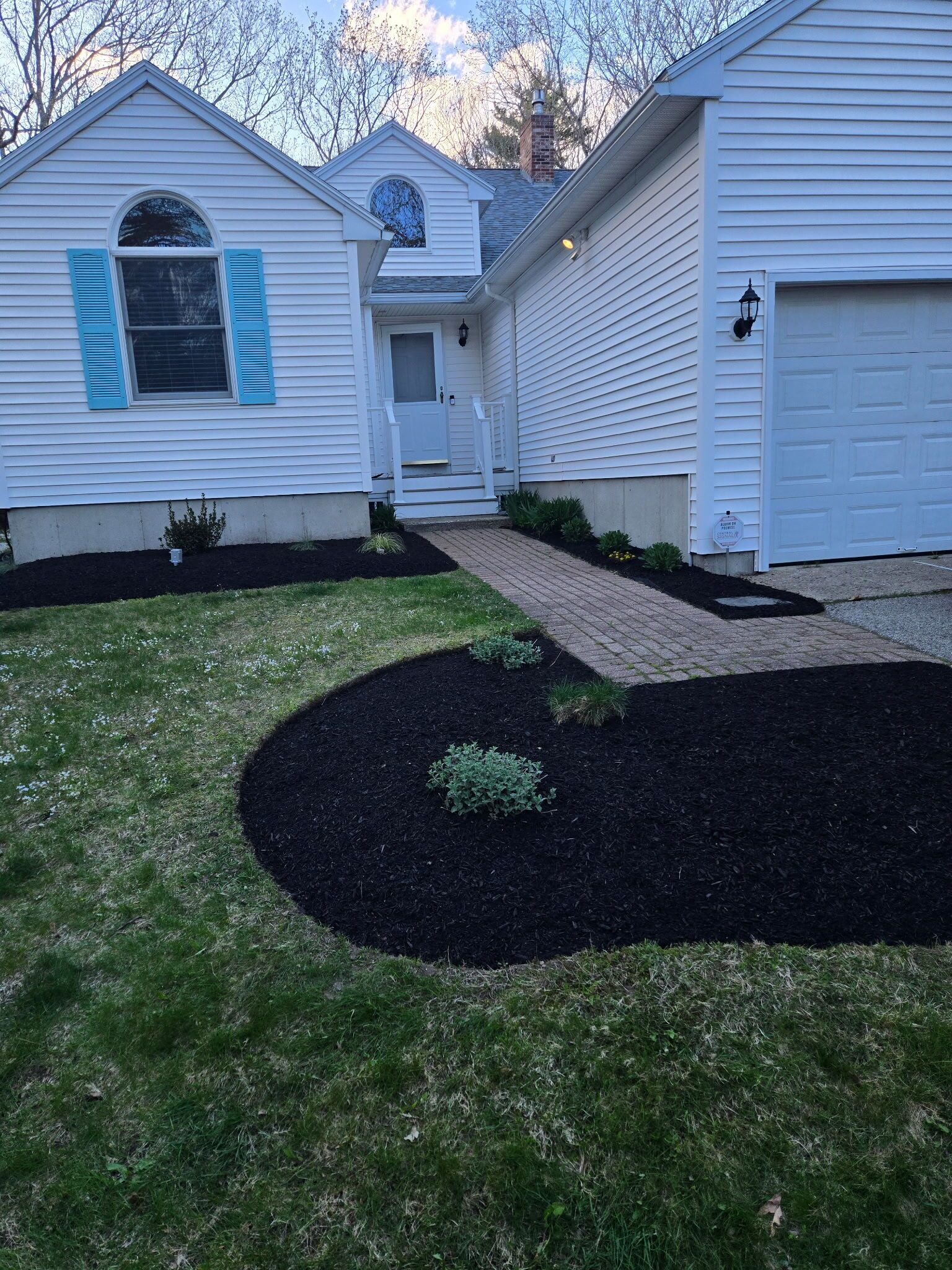 A residential house with a front yard, a driveway, and a garage.