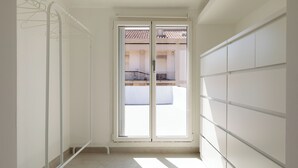 A narrow hallway with a sliding glass door leading to a balcony. - Romantic Apartment with Terrace by Wonderful Italy (Olbia)
