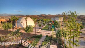 A resort with a large dome structure, a playground, and a staircase leading to a pool area. - The Ranch Resort - Family Tent (Tahannaout)