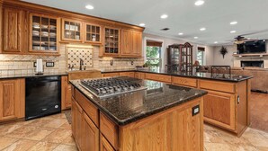 A kitchen with wooden cabinets, a built-in stove, and a dishwasher.