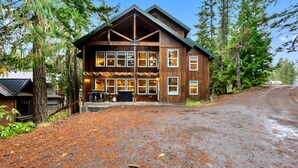 A rustic lodge with a large front porch, multiple windows, and a gravel driveway. - Evergreen House in heart Government Camp (Government Camp)