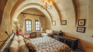 A bedroom with a bed, a chair, a desk, and a window. - Hush Cappadocia (Urgup)