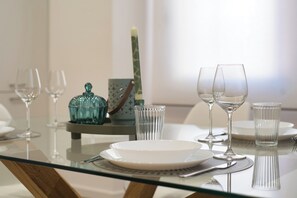 A dining table set with plates, glasses, and cutlery.