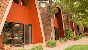 A modern building with a unique architectural design, featuring large glass windows and a red facade. - Charming Chalet with Kitchen and Scenic Views.  (Sedona)
