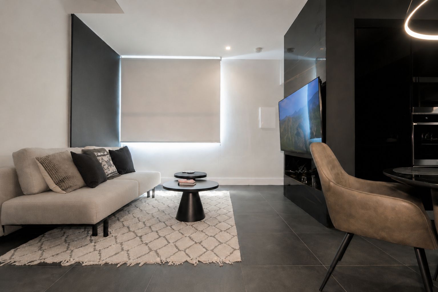 A modern living room with a sofa, coffee table, and a TV.