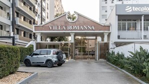 The entrance to Villa Romanna, featuring a modern design with a prominent entrance and a parked car.
