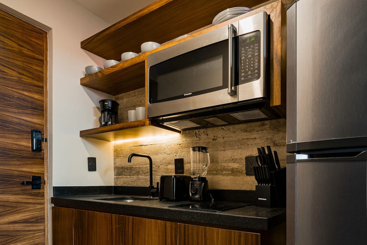 Full-sized fridge, microwave, stovetop, coffee/tea maker