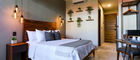 A neatly arranged bedroom with a wooden headboard, a bed with white bedding, bedside tables with lamps, a small plant, and a wall-mounted shelf with potted plants.