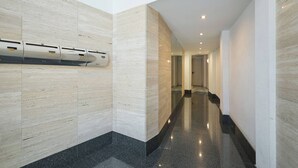 A modern hallway with a polished floor and light-colored walls.
