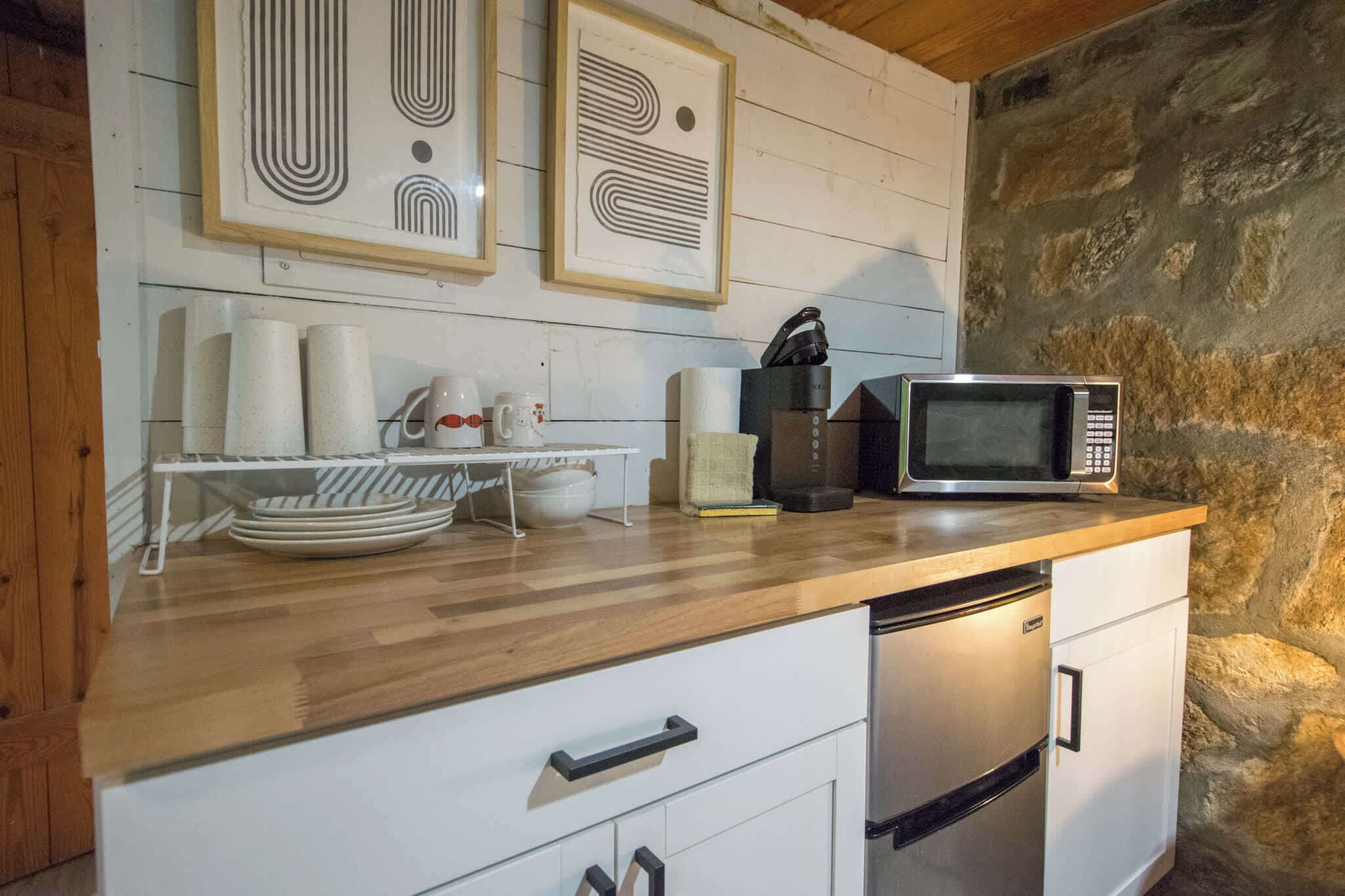 Fridge, microwave, coffee/tea maker, cookware/dishes/utensils