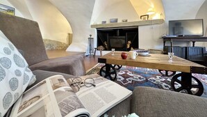 A cozy living room with a fireplace, a television, and a comfortable seating area.