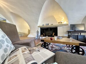 A cozy living room with a fireplace, a television, and a comfortable seating area.